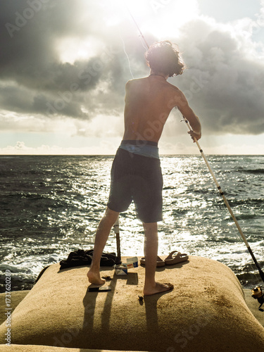 young man fishing on the beach