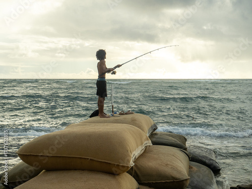 man fishing on the beach