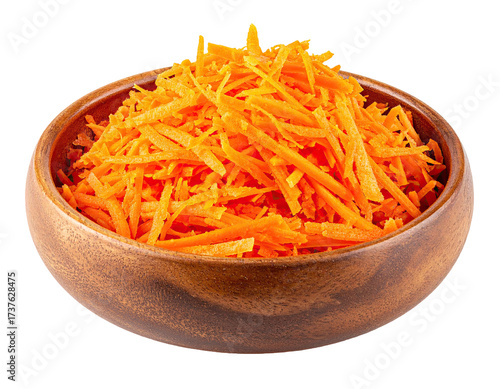 Close-up of shredded orange carrots inside a round, wooden bowl