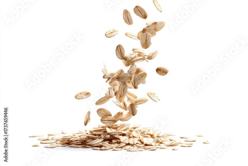 Rolled oats in motion, levitating and falling onto a pile against a stark white background