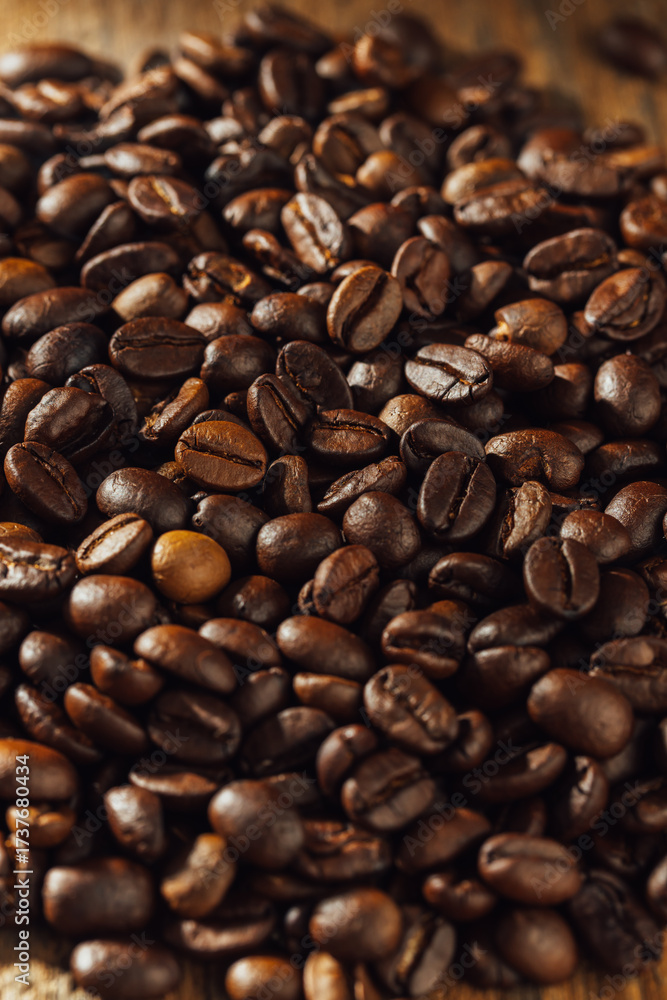 Fototapeta premium Close-Up of Roasted Coffee Beans on a Wooden Surface Background