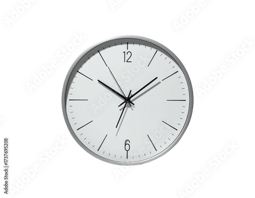 A close-up image of a minimalist, modern clock with black hands on white face