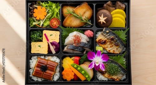 Artfully arranged Japanese bento box offers a healthy and delicious variety of sushi, fish, and vegetables for a quick lunch or dinner on the go