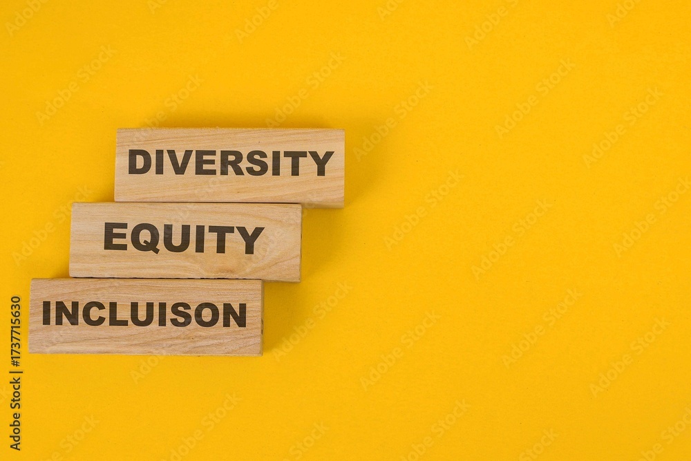 Naklejka premium Diversity, Equity, And Inclusion Words On Wooden Blocks Over Yellow Background