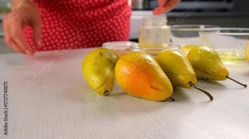 Pastry chef puts pears with nuts filling on table cooking dessert on kitchen. Creating delicious healthy food. Cuisine culinary prepare homemade cook dish domestic healthy meal recipe ingredients.