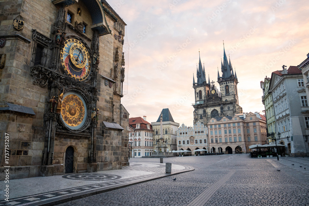 Fototapeta premium Stunning sunrise over Prague with warm golden light illuminating historic architecture, cobblestone streets, and iconic city landmarks in high-quality detail.