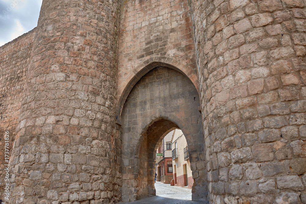 Fototapeta premium A journey into the past through the Puerta de Herreros, Almazan, Soria, with its stone arches and towers