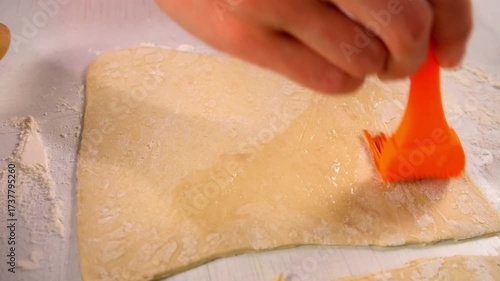 Baker woman hands smearing dough silicone brush with egg white cooking dessert. Create delicious healthy food pastry. Cuisine culinary prepare homemade cook domestic meal baking recipe ingredients.