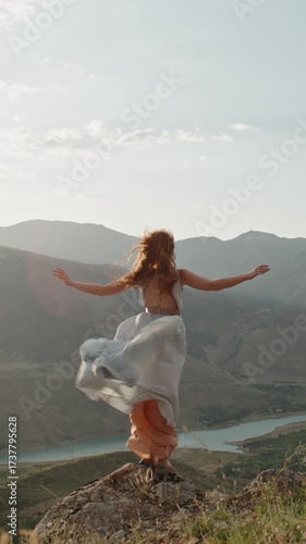Wallpaper Mural Slow motion vertical video redhead woman standing arms wide mountain peak windy river valley cinematic lifestyle freedom inspiration beauty nature mindfulness Torontodigital.ca