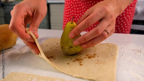 Pastry chef woman cooking dessert wrapping filled pear in dough on kitchen. Create delicious healthy food pastry. Cuisine culinary prepare homemade cook domestic meal baking recipe ingredients.