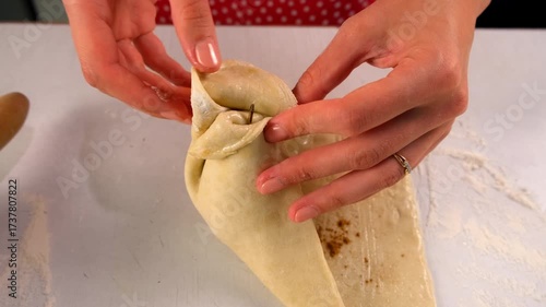 Pastry chef woman cooking dessert wrapping filled pear in dough on kitchen. Create delicious healthy food pastry. Cuisine culinary prepare homemade cook domestic meal baking recipe ingredients.