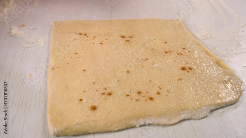 Pastry chef woman sprinkling cinnamon on fresh dough on kitchen cooking dessert. Create delicious healthy food pastry. Cuisine culinary prepare homemade cook domestic meal baking recipe ingredients.