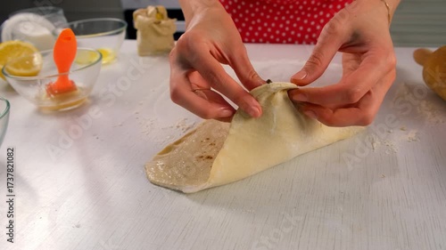 Pastry chef woman cooking dessert wrapping filled pear in dough on kitchen. Create delicious healthy food pastry. Cuisine culinary prepare homemade cook domestic meal baking recipe ingredients.