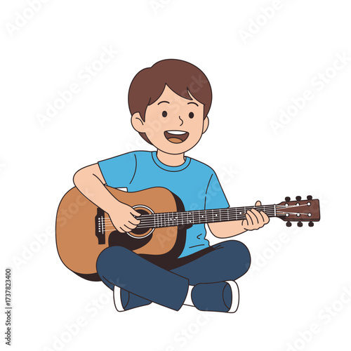A young boy with brown hair sits playing an acoustic guitar, smiling happily.