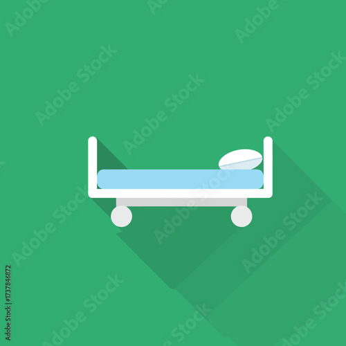 Hospital bed with pillow and blue mattress on wheels.