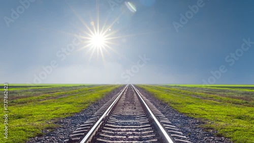  railway among green plain under a sparkle sun time lapse scene
