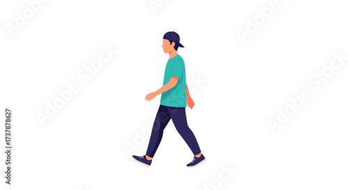 A young man wearing a blue t-shirt and dark pants walks outdoors.