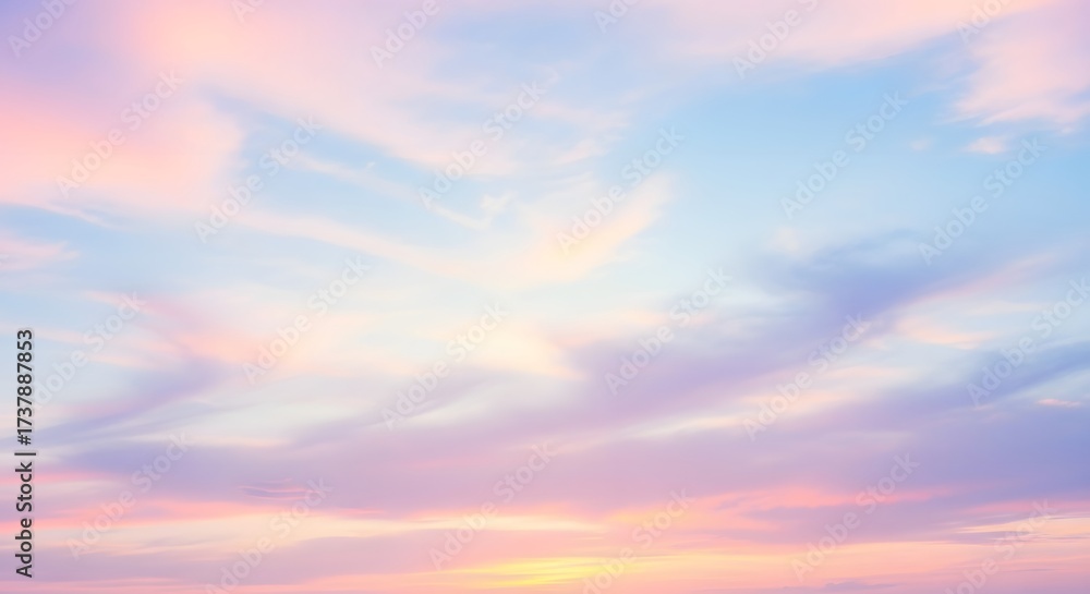 Fototapeta premium Serene pastel sunset sky with wispy clouds, creating a tranquil atmosphere for relaxation