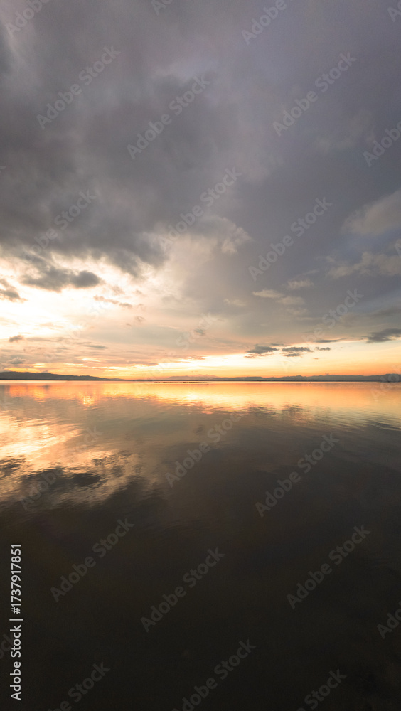 Fototapeta premium Cloudscape Reflection on Calm Water at Sunset