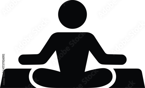 Black silhouette icon of a person meditating on a mat yoga