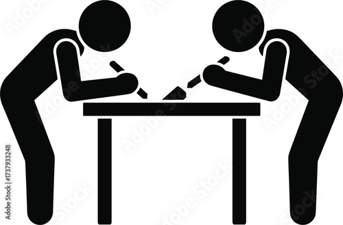 Two people writing at a table with pens and paper desk