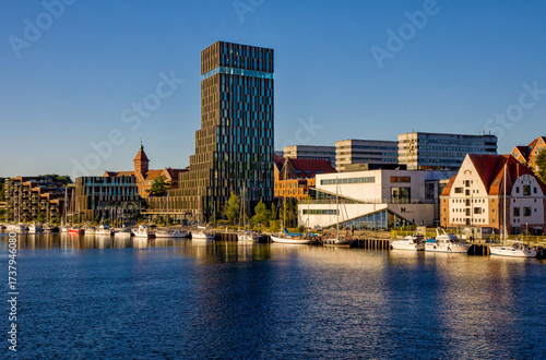 cityscape of the new harbor promenade in the danish city of Sonderborg with blue sky and evening sunlight 