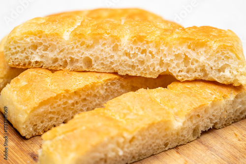 Delicious Italian Focaccia Loaf Slices on Wooden Board – Rustic Food Style