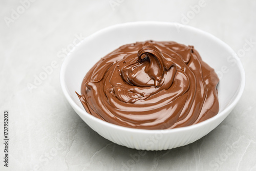 Delicious Chocolate Cream in White Bowl on Table – Sweet Dessert Close Up