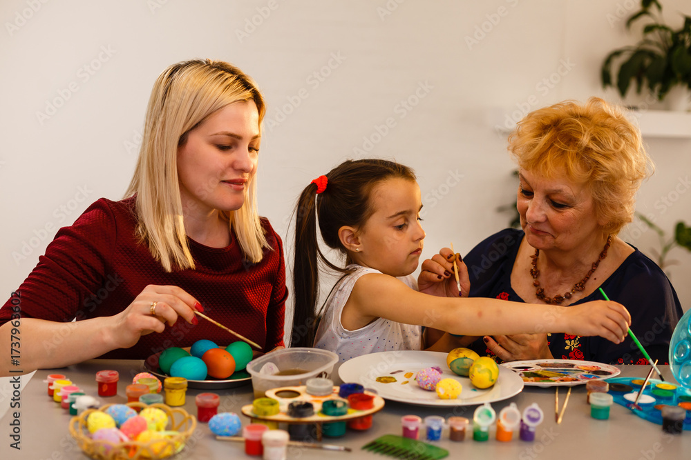 Fototapeta premium grandmother with granddaughter play with easter eggs, easter time to paint eggs.