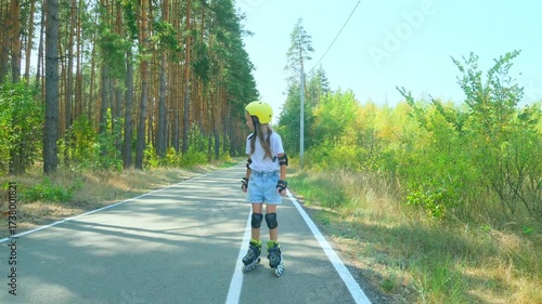 Wallpaper Mural Girl is roller skating by forest, enjoying an active hobby in the open air. Torontodigital.ca