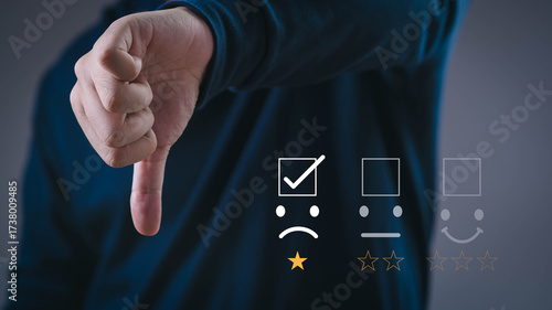 Fotografie Customer showing thumbs down with poor rating feedback icon, concept of negative review, dissatisfaction, low quality service, bad customer experience, business failure, online reputation management