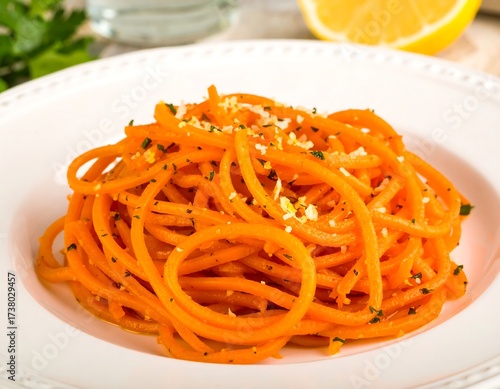 Orange pasta dish on white plate