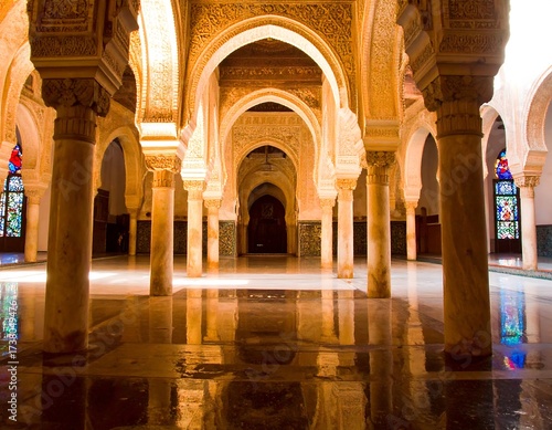 Ornate arches and columns in a sunlit hall