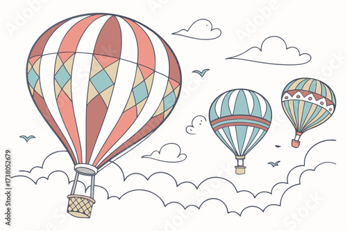 Three colorful hot air balloons floating among clouds