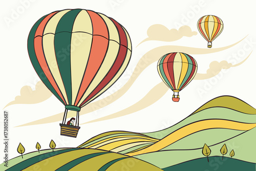 Three colorful hot air balloons over rolling hills