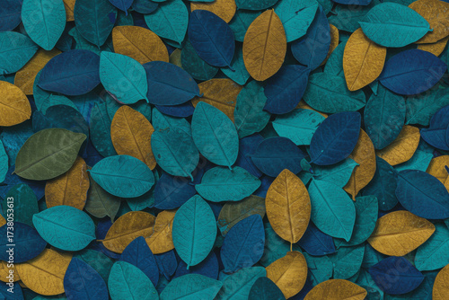 A macro shot, top-down view of a dense, overlapping pattern of stylized leaves. The leaves are primarily oval or teardrop-shaped, with visible veining and subtle texture