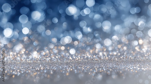 Abstract background of blue and silver sparkling bokeh lights, representing a winter holiday atmosphere. Dreamy and elegant
