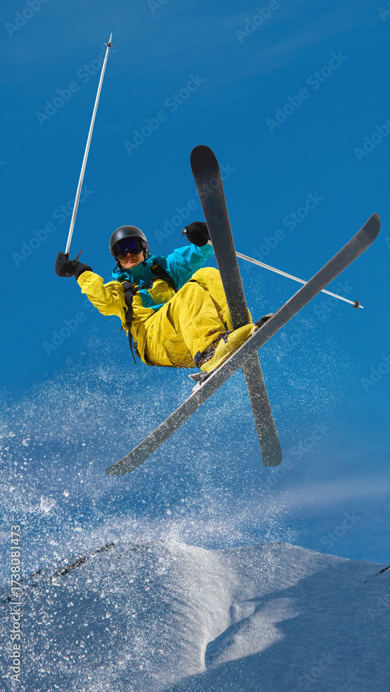 Naklejka premium Male skier performing freestyle aerial jump with crossed skis in snow park. Concept of freestyle competition ads, extreme winter campaigns, lifestyle branding and sport promotion. Hand made collage