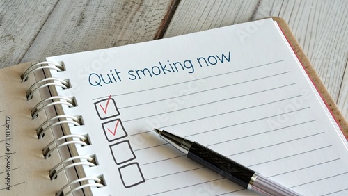 Notebook page with quit smoking checklist and a pen ready