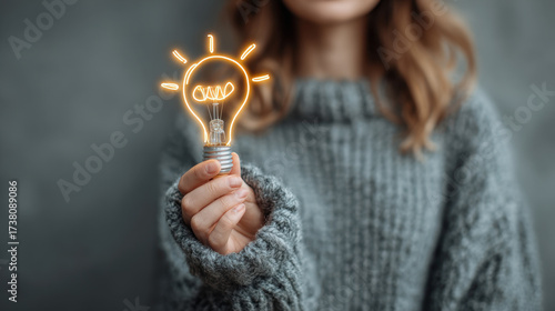 woman holding light bulb
