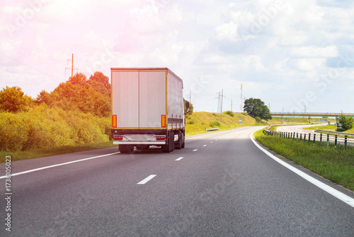 Wallpaper Mural A modern semi-trailer truck transports cargo along a highway on a sunny day. Concept of payment for cargo transportation, price for freight. Copy space for text, industry Torontodigital.ca