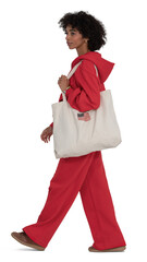 Black woman in a red jumper and joggers walking in side view, isolated on white and transparent background