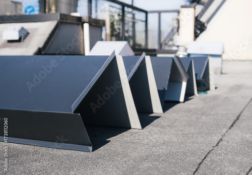 New roof metal flashing or metal coping before installation. Custom sheet metal fabrication to repair or install flat roof wall with modified bitumen. Large metal corners. Selective focus.