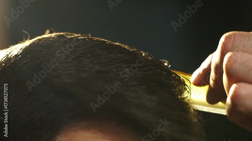 Groom preparing for wedding ceremony, meticulously styling hair with a comb, showcasing attention to detail and elegance in a softly lit atmosphere, capturing the essence of wedding preparations