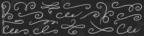 Collection of hand drawn white decorative swirls and flourishes on black background