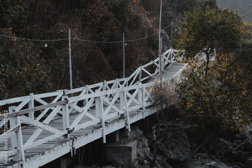 The Serene White Bridge Gracefully Stretched Over Tranquil Waters in a Beautiful Scenic Landscape