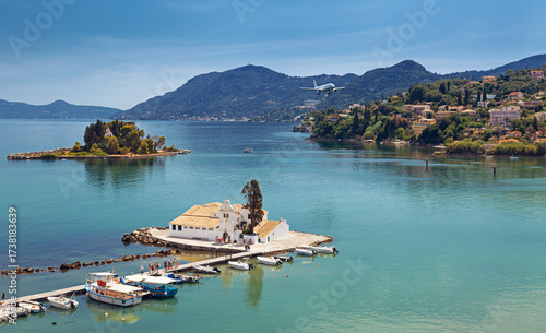 Typical view of Vlacherna Monastery and Mouse island with airplane landing, Corfu, Greece.