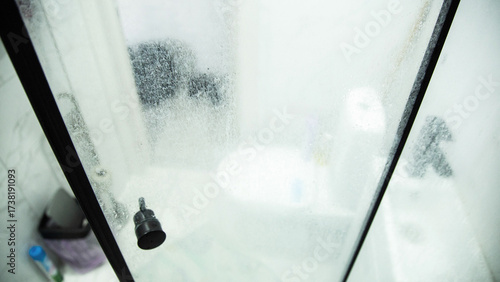 White marks and hard water stains on the transparent shower doors in the bathroom. Unsanitary and Hygiene Cleaning Solution, industry