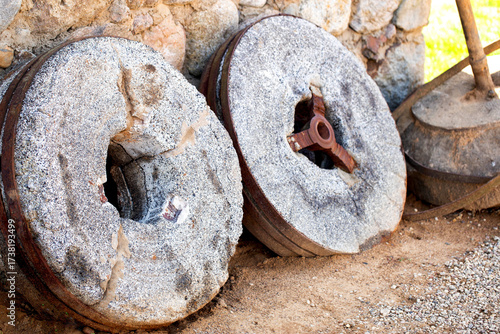 Bild auf Leinwand Old, used stone millstones from a mill used to grind grain into flour, museum ex
