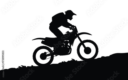 Silhouette of a motocross rider ascending a hill in a dynamic pose